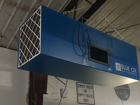 Blue Ox industrial air filtration system installed in a welding workshop.