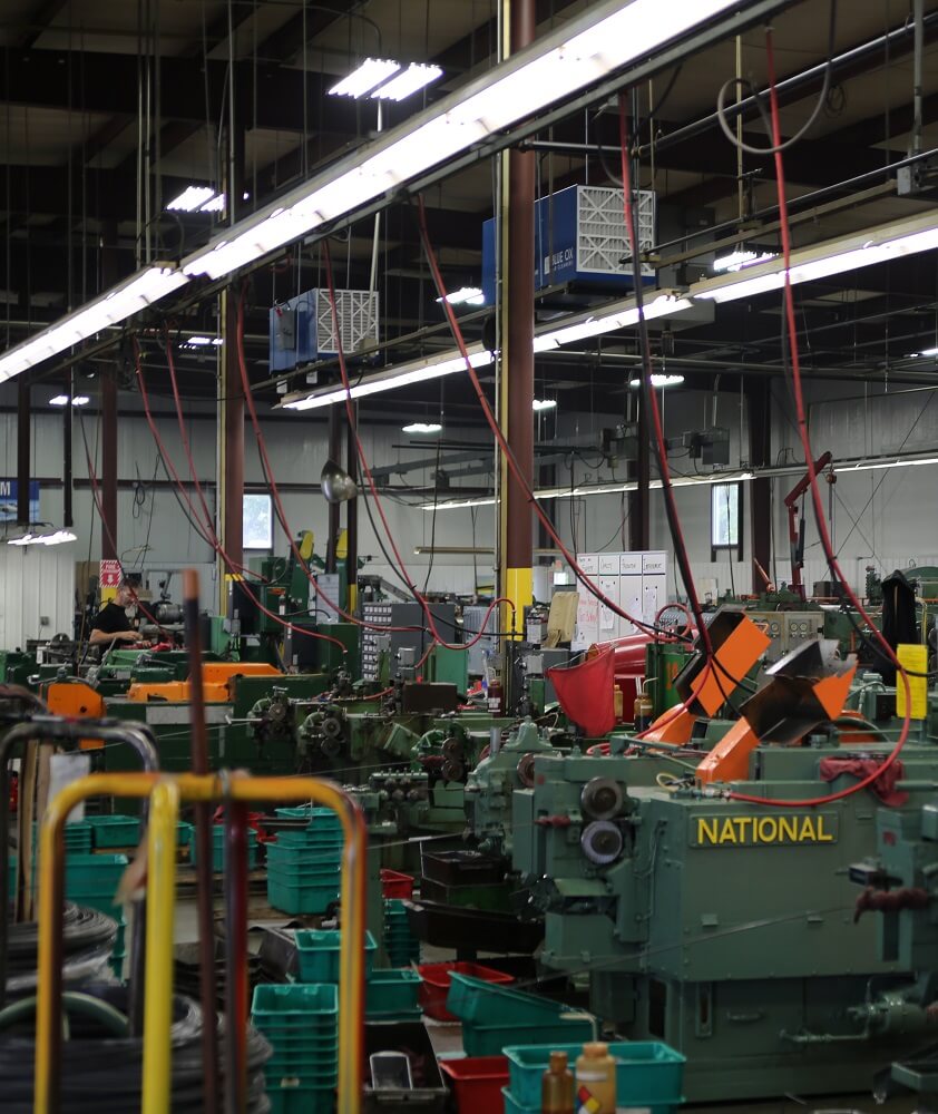 Blue Ox air filtration systems installed in an industrial machining facility to improve indoor air quality.