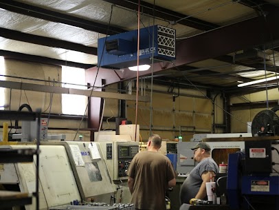 Machine operators at work with a Blue Ox air filtration system installed on the ceiling above them.