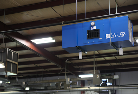 Blue Ox HEPA air filtration system shown installed in an industrial facility to remove heavy particulate.
