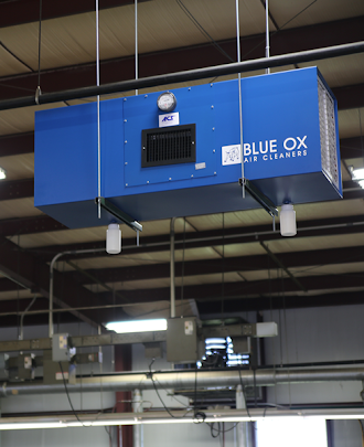 A Blue Ox ambient air cleaner shown installed in an industrial facility to removal welding smoke and dust.