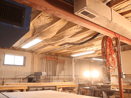 Woodshop air filtration system installed in a home-based workshop.