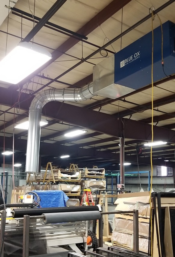 Blue Ox woodshop air filtration system shown ducted in a large industrial facility.