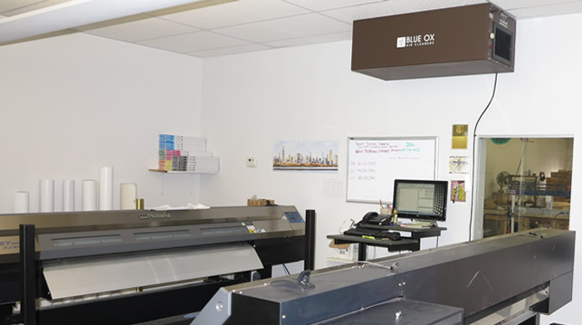 A Blue Ox OX1100-CC air cleaner shown installed above a work area at Canvas Print Shop to remove print solvents.