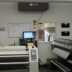 A Blue Ox OX1100-CC in the color brown, shown installed above a work area at Canvas Print Shop.